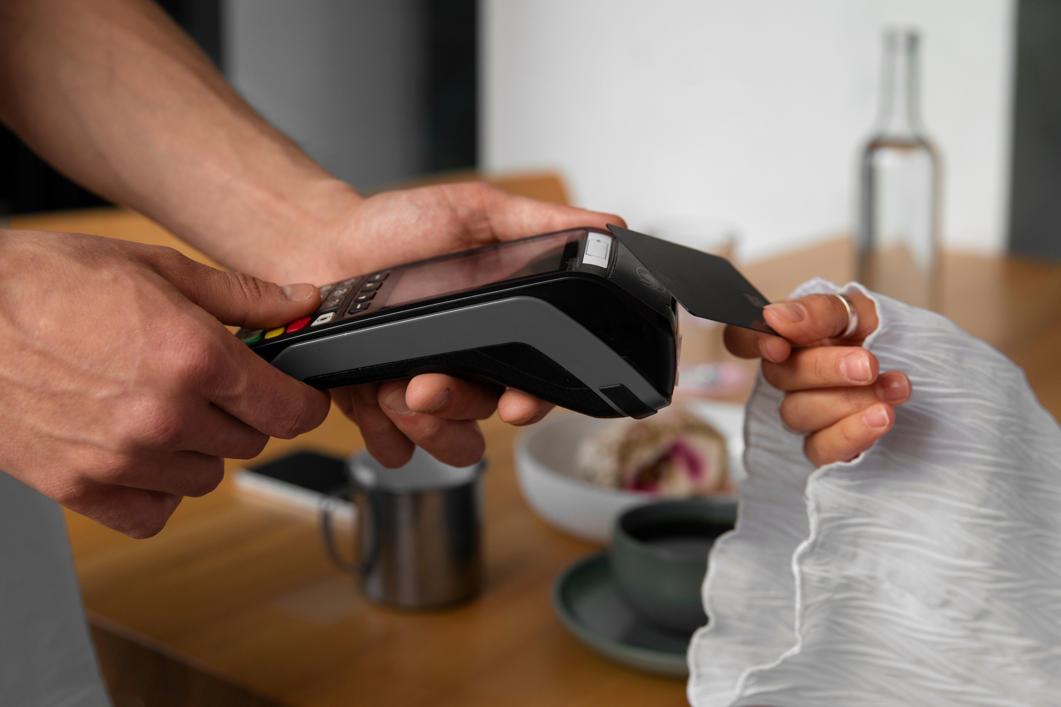 side-view-customer-paying-with-nfc-device 1